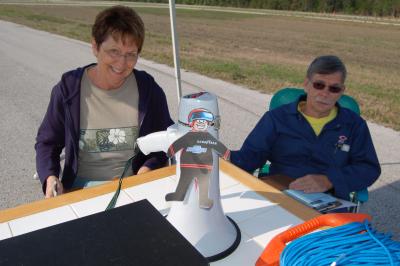 Flat Stanley visits with the timing and scoring workers